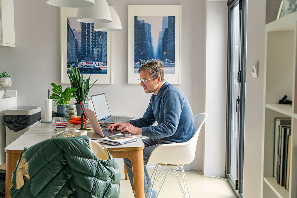 Ein mann macht homeoffice vom Esstisch aus.